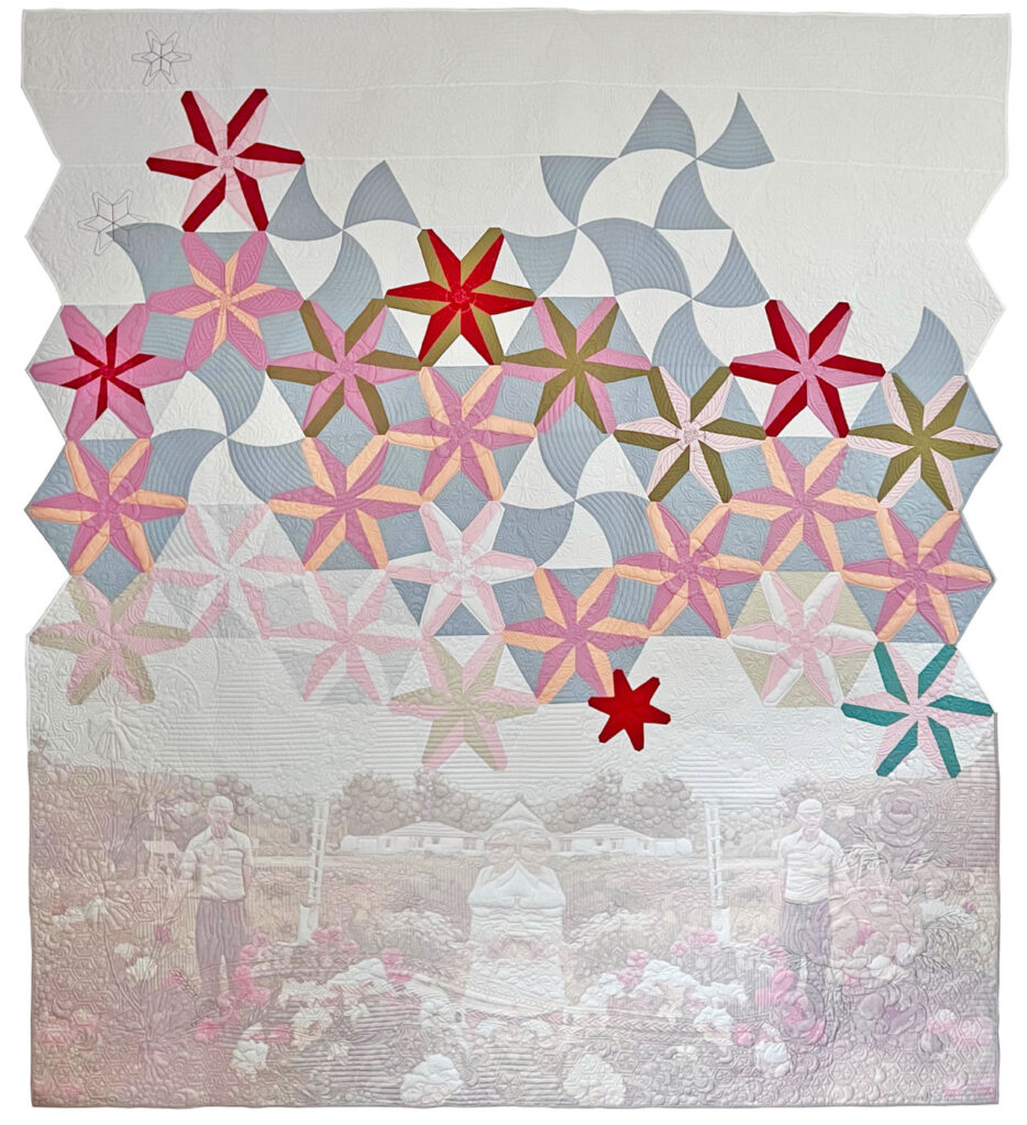 A quilt with a mirror image of a faded photograph of a man and a woman standing in their garden, pastel pinwheel designs float above on a white background.