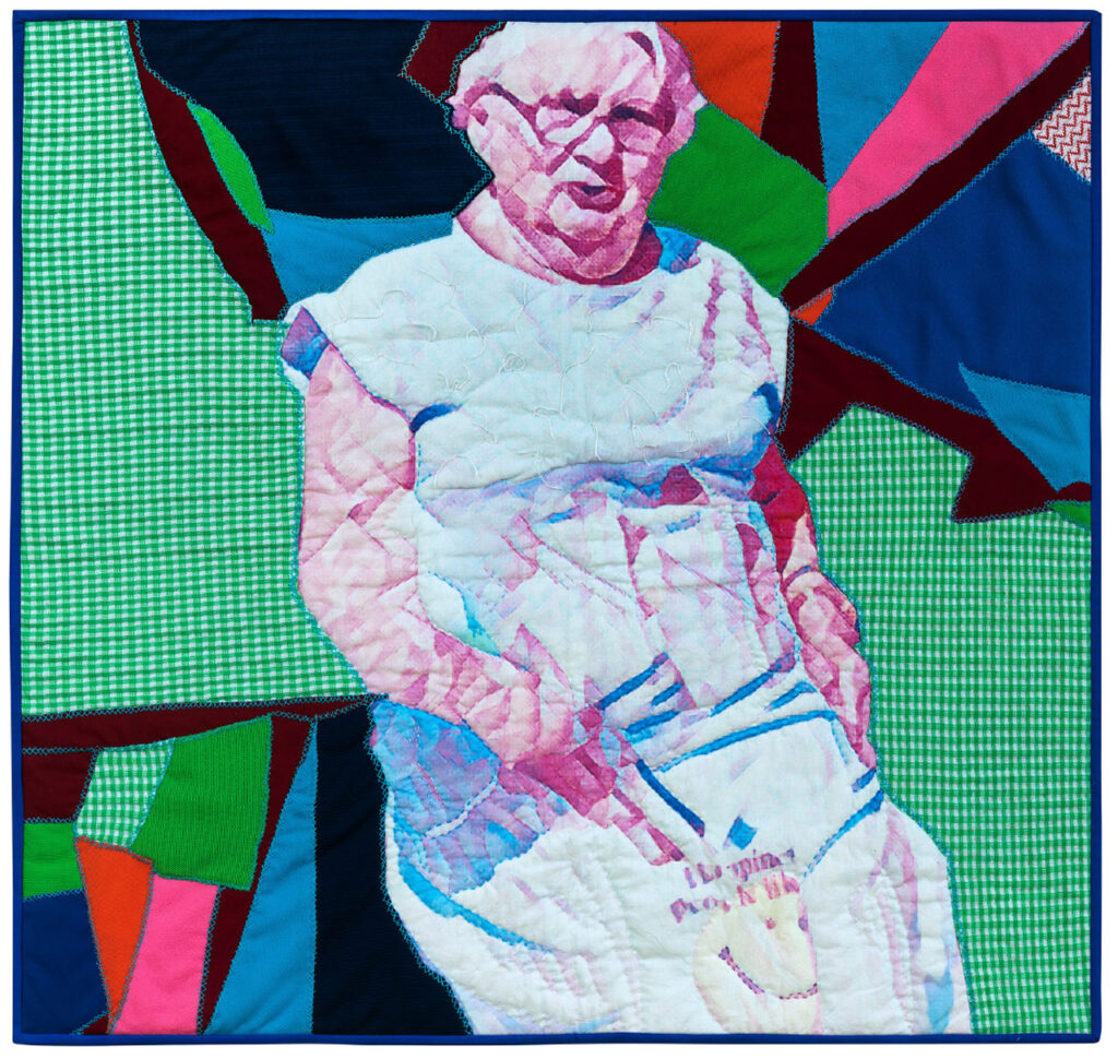 A bright, scrappy quilt with a realistic portrait of an elderly woman as the central design.