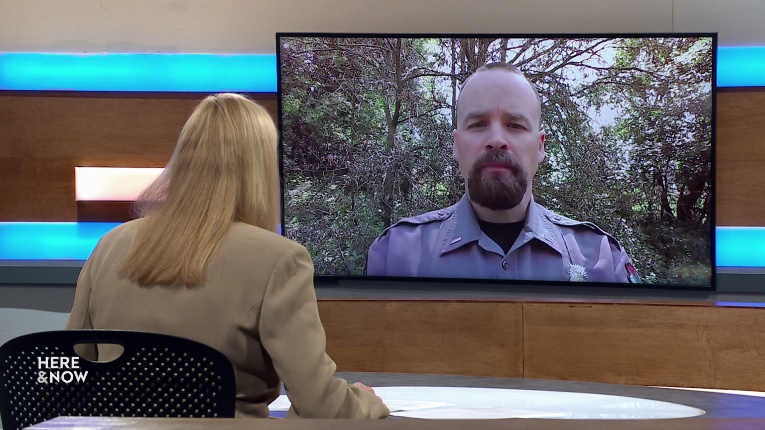 Frederica Freyberg sits at a desk on the Here & Now set and faces a video monitor showing an image of Jake Holsclaw. Frederica Freyberg sits at a desk on the Here & Now set and faces a video monitor showing an image of Jake Holsclaw.