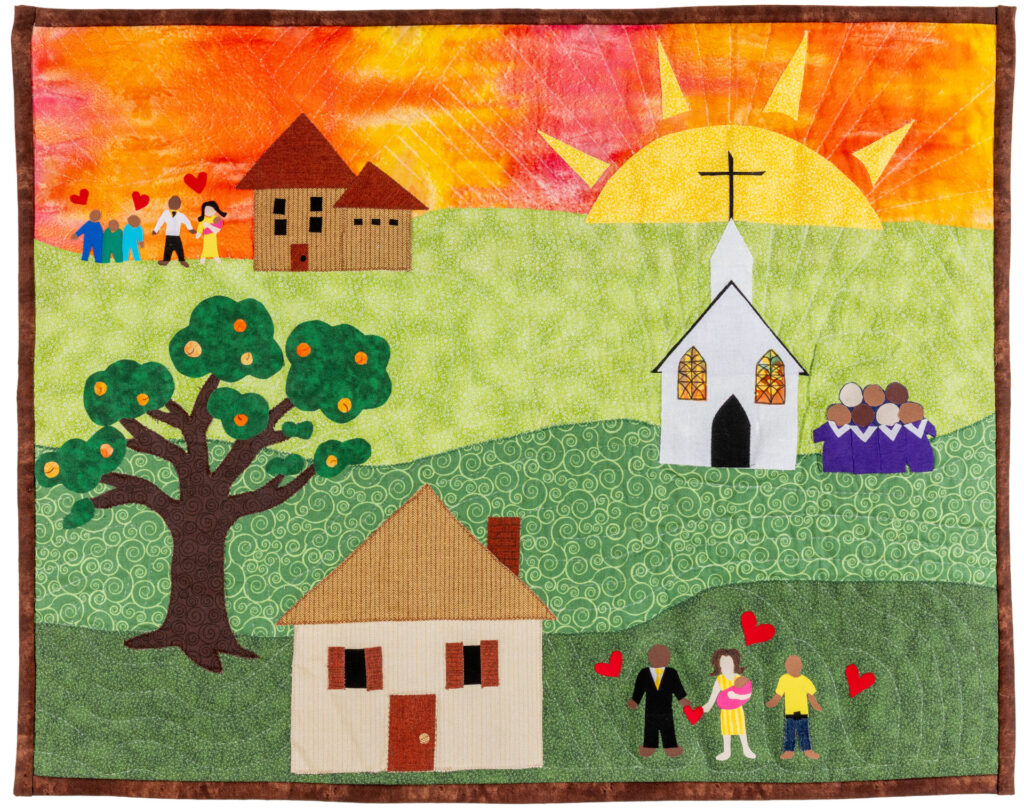 A landscape quilt of a community centered around a church.