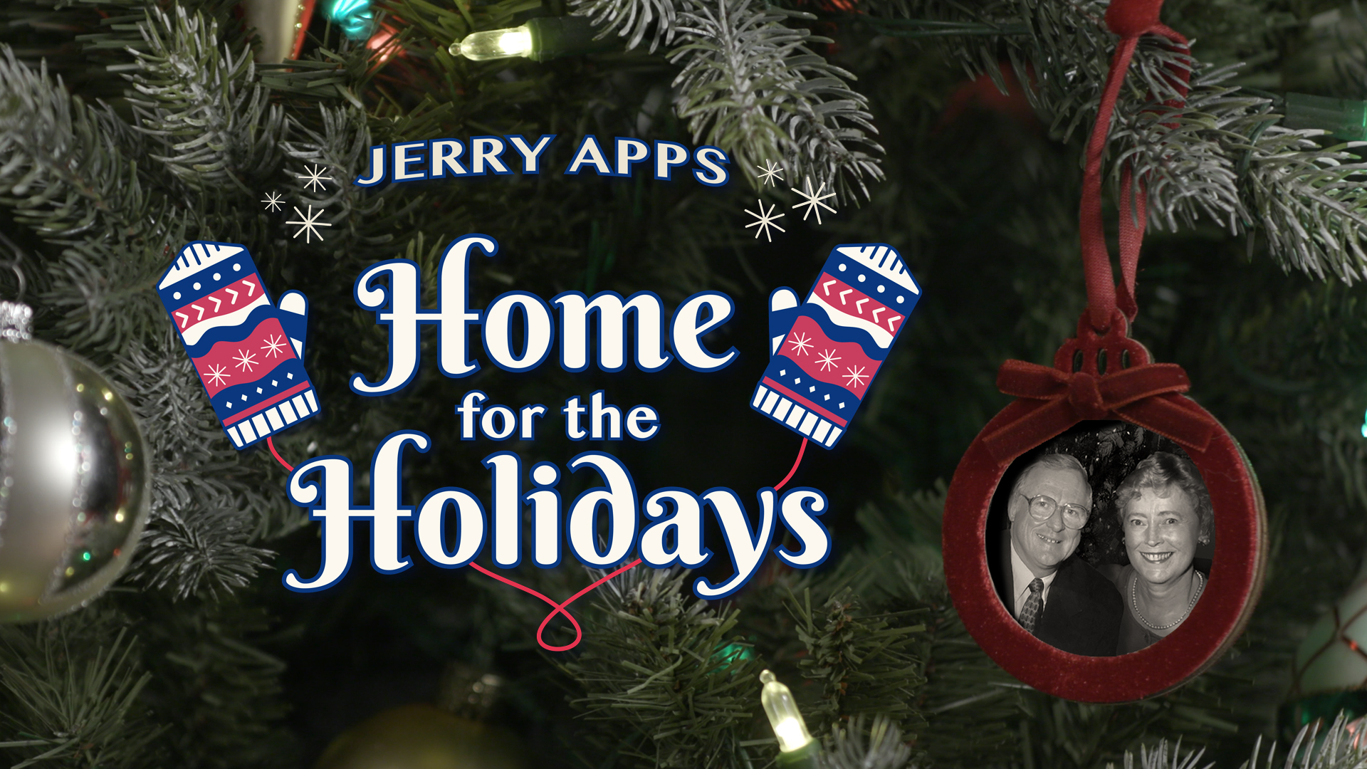 Title card for Jerry Apps: Home for the Holidays, set against a lit Christmas tree with patterned mittens beside the title and a red ornament framing a black-and-white photo of Jerry Apps and his wife.