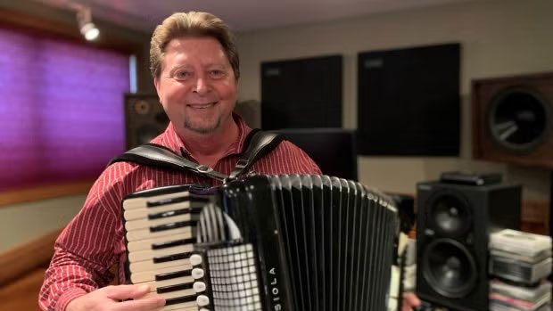 A man holding an accordion.