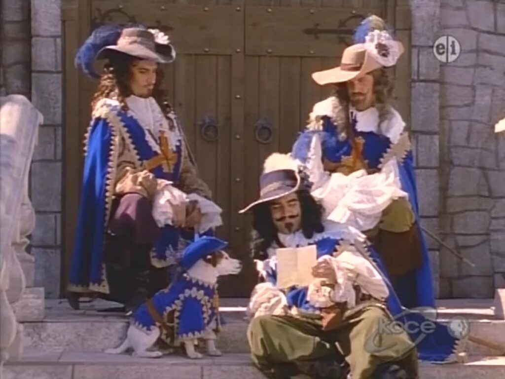 Three men and a dog are dressed in 18th century French garb.