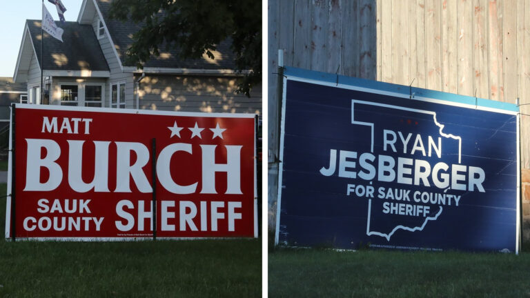 Side-by-side photos show campaign yard signs — one with the words Matt Burch and Sauk County Sheriff and the other with the words Ryan Jesberger for Sauk County Sheriff — displayed in lawns in front of a house and barn, respectively. Side-by-side photos show campaign yard signs — one with the words Matt Burch and Sauk County Sheriff and the other with the words Ryan Jesberger for Sauk County Sheriff — displayed in lawns in front of a house and barn, respectively.